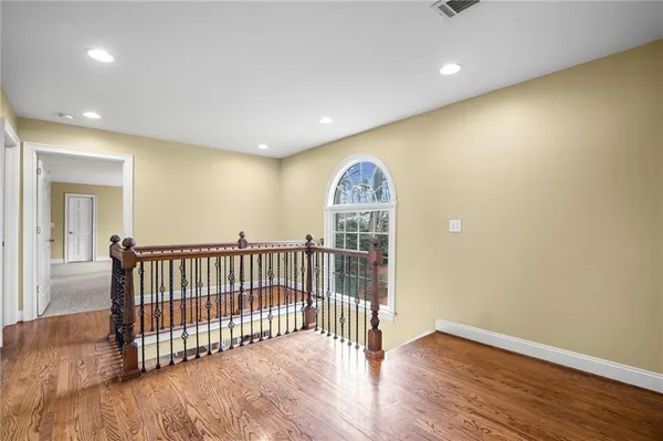 a view of a room with wooden floor
