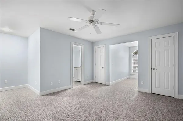 a view of an empty room with a ceiling fan