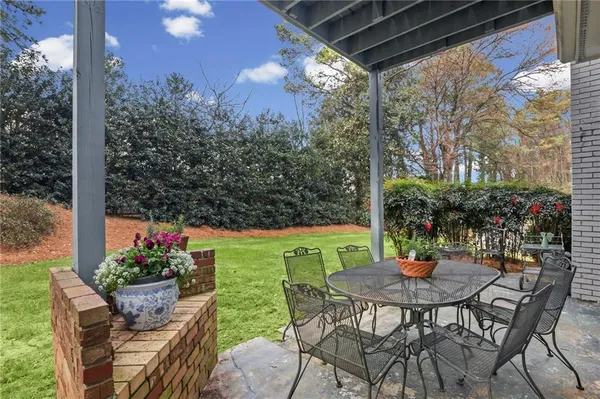 a view of an outdoor dining space with a table and chairs