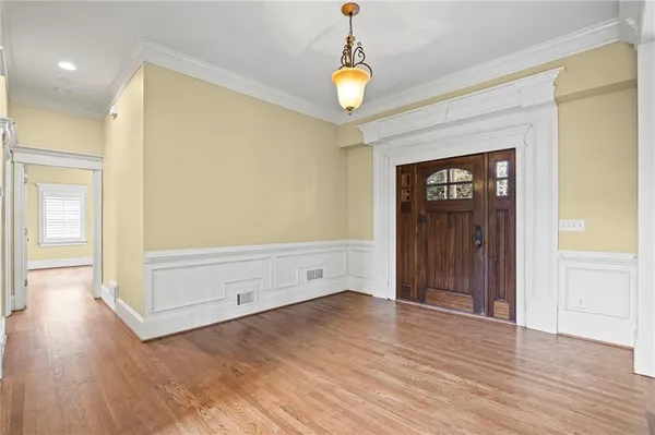 a view of empty room with wooden floor