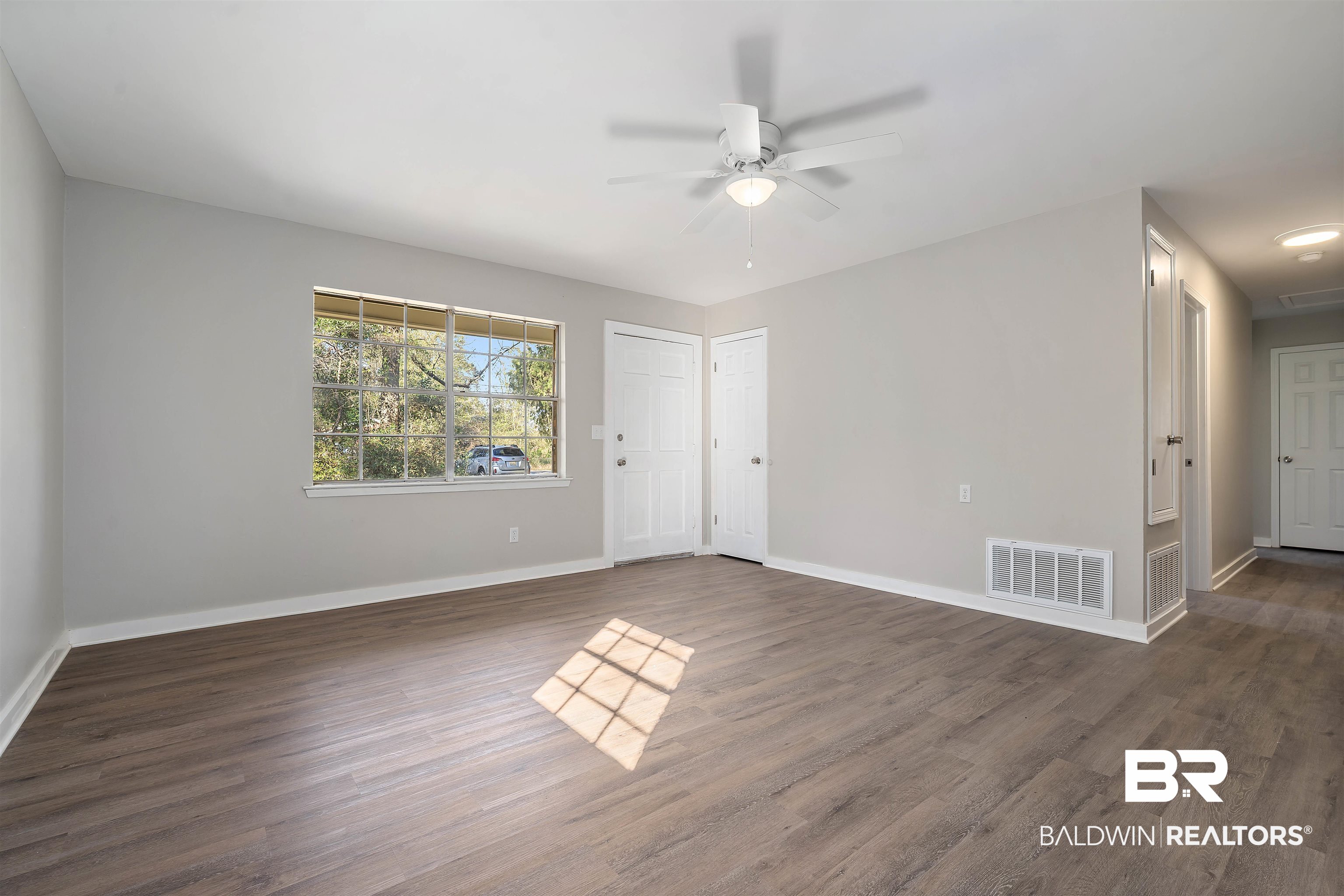 1368 Hubert Pierce Road Mobile, AL 36608 - Photo 6 of 25 Unfurnished room featuring dark wood-type flooring and ceiling fan