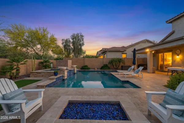 a front view of a house with swimming pool having outdoor seating