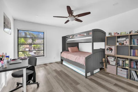 a bedroom with furniture and a book shelf