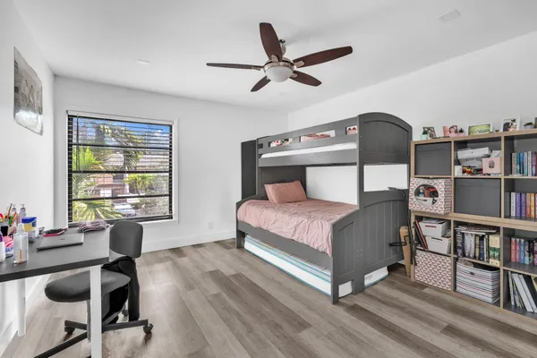 a bedroom with furniture and a book shelf