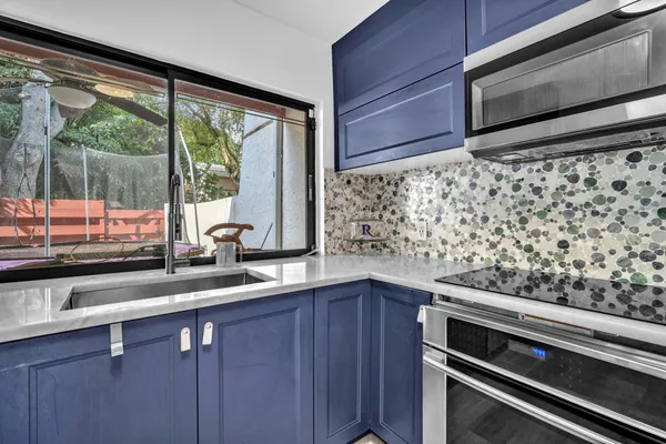 a kitchen with a sink and large window