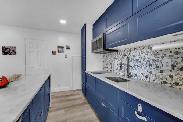 a kitchen with stainless steel appliances wooden cabinets and a sink