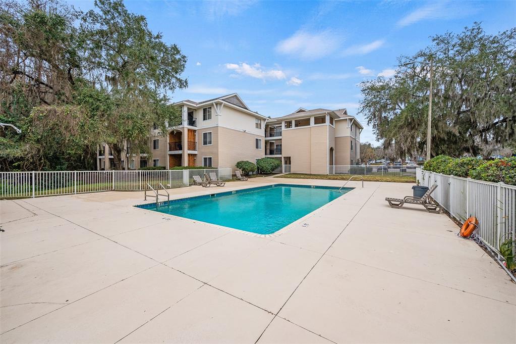3921 Southwest 34th Street, Unit 208 Gainesville, FL 32608 - Photo 33 of 33 a view of a house with backyard and trees