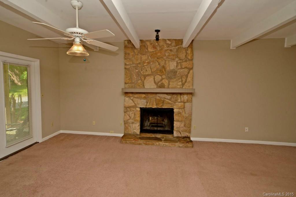 4731 Rounding Run Road Charlotte, NC 28277 - Photo 6 of 24 an empty room with a fireplace and fan