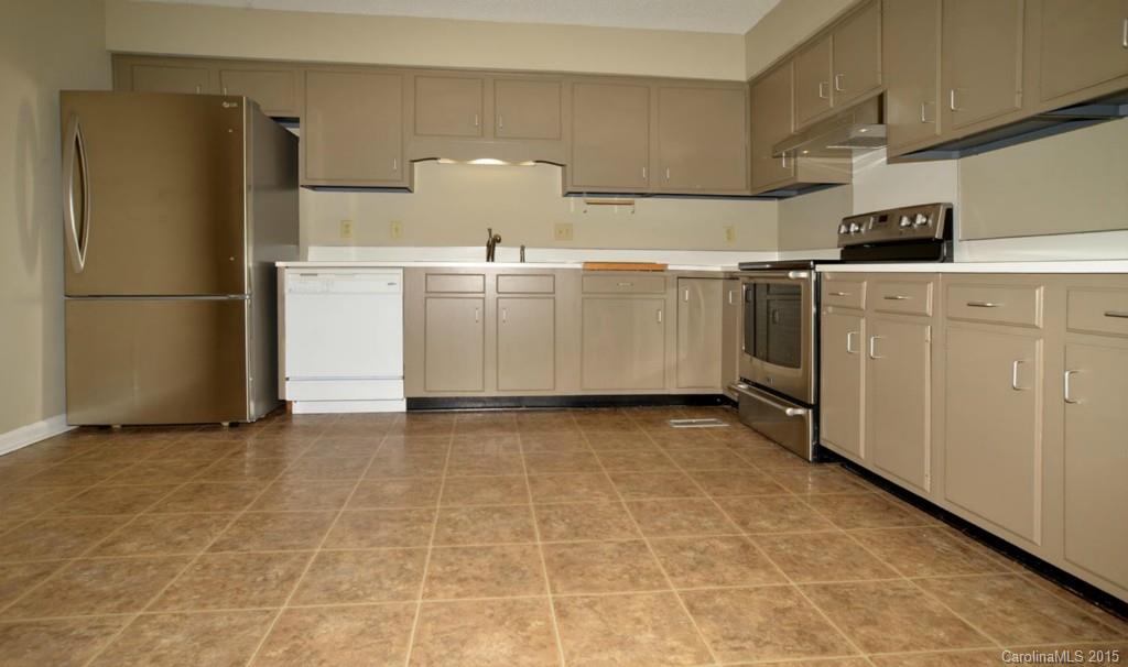 4731 Rounding Run Road Charlotte, NC 28277 - Photo 9 of 24 a view of a kitchen with refrigerator and white cabinets