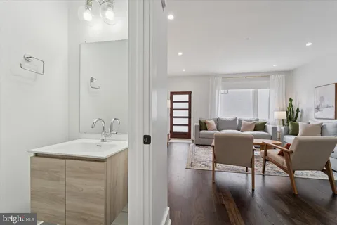 a view of a dining room with furniture a rug and wooden floor