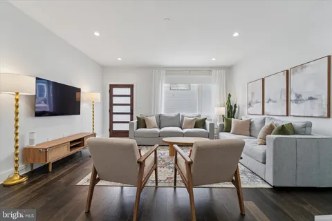 a living room with furniture fireplace and a window