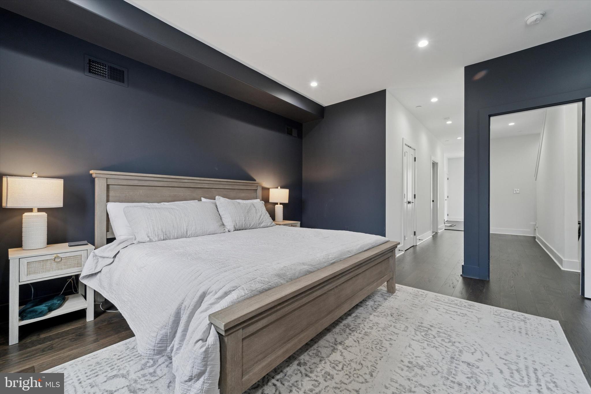 73 East Sharpnack Street Philadelphia, PA 19119 - Photo 22 of 50 a bedroom with a bed and a lamp