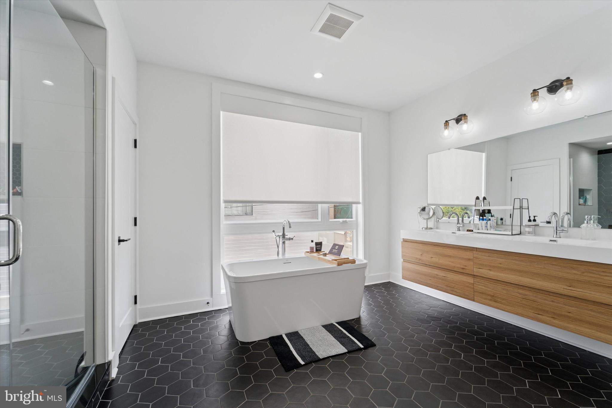 73 East Sharpnack Street Philadelphia, PA 19119 - Photo 25 of 50 a bathroom with a sink mirror and a bathtub