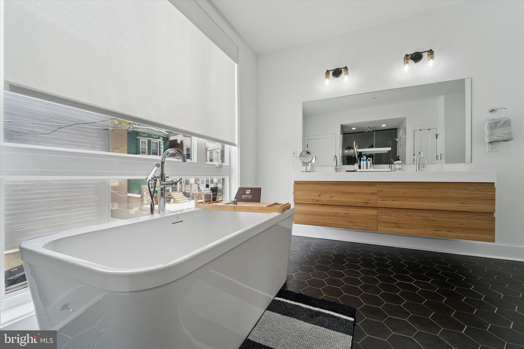73 East Sharpnack Street Philadelphia, PA 19119 - Photo 26 of 50 a bathroom with a sink and a mirror