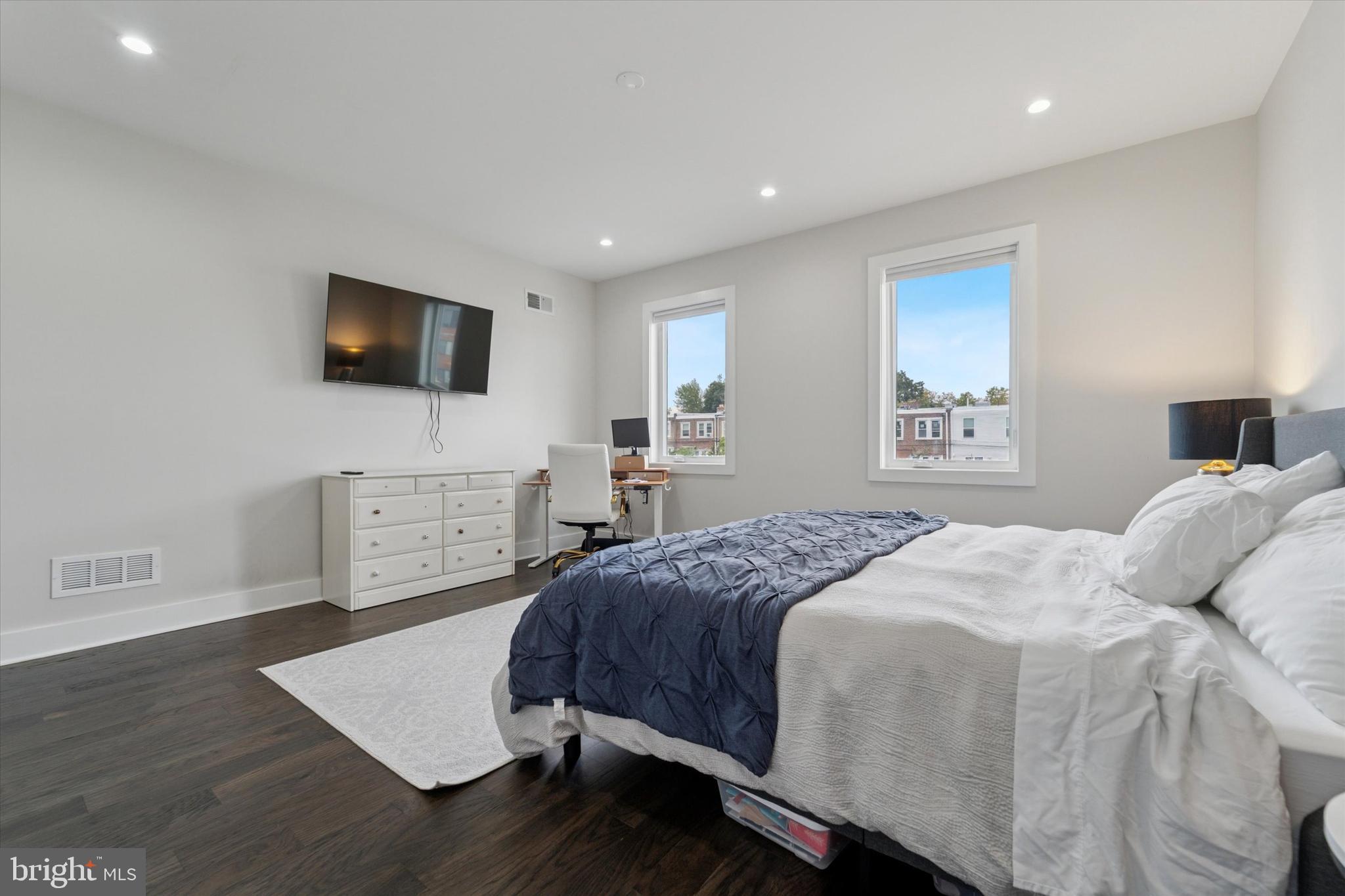 73 East Sharpnack Street Philadelphia, PA 19119 - Photo 28 of 50 a bedroom with a bed and a flat screen tv