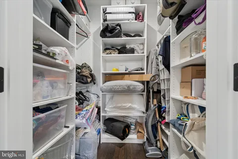 a spacious bedroom with a bed and a flat screen tv