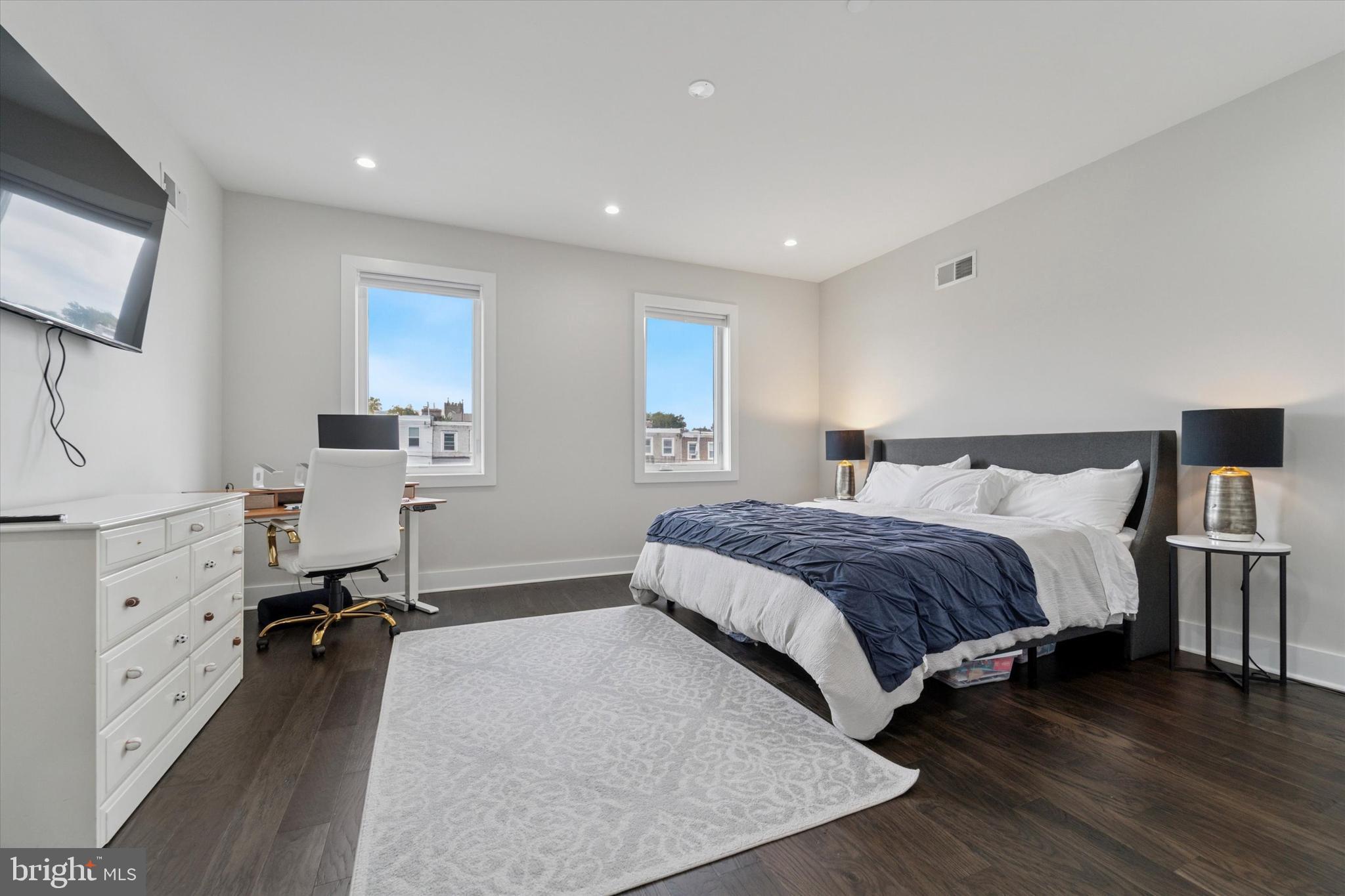 73 East Sharpnack Street Philadelphia, PA 19119 - Photo 30 of 50 a spacious bedroom with a bed and a flat screen tv