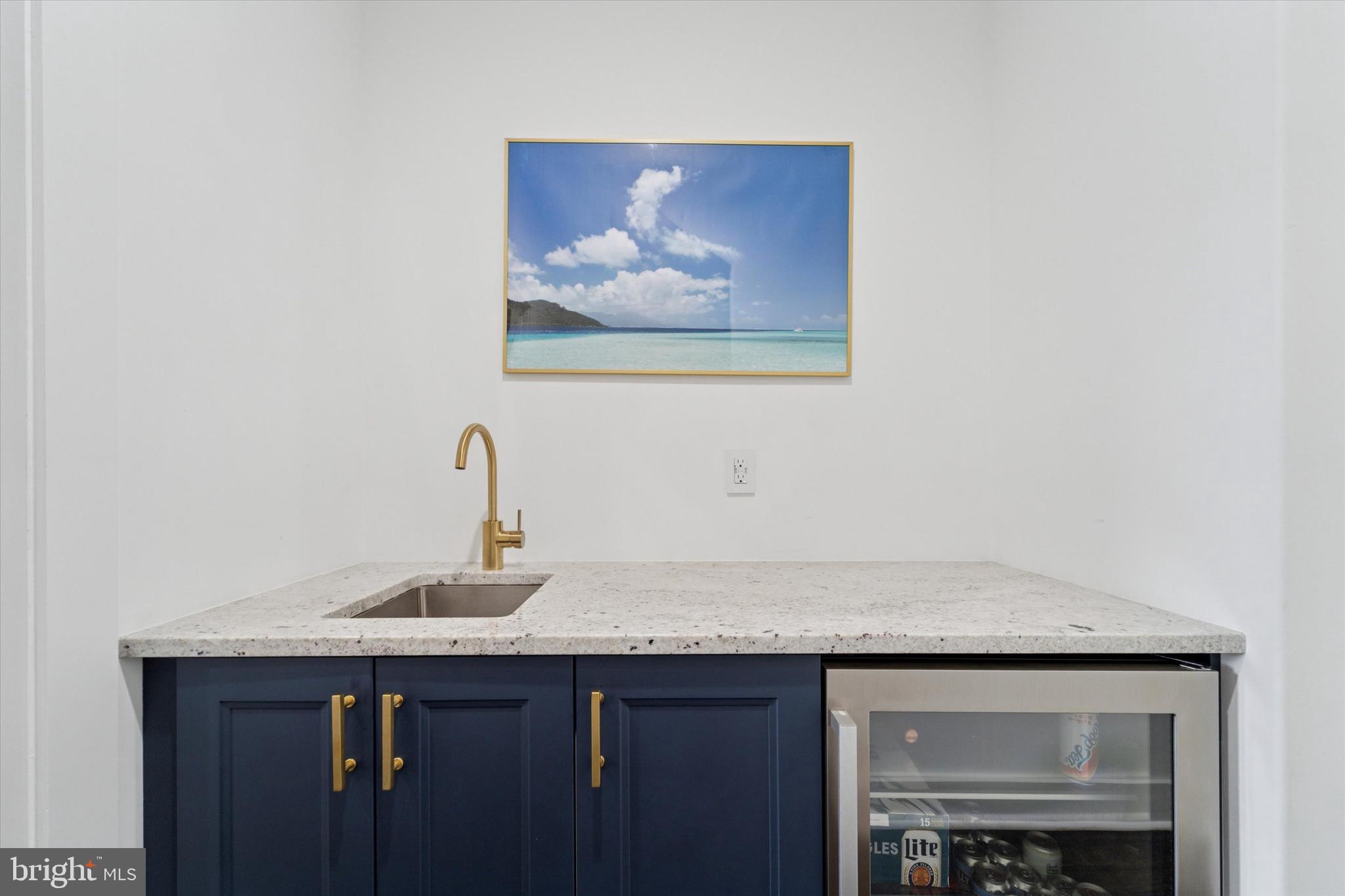 73 East Sharpnack Street Philadelphia, PA 19119 - Photo 36 of 50 a bathroom with a granite countertop sink and a mirror