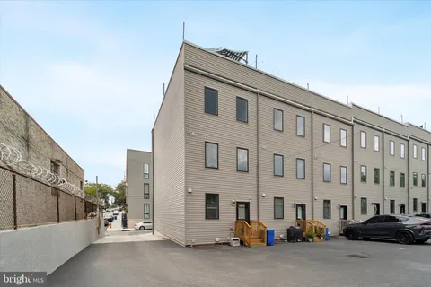 a city street lined with parked cars and buildings