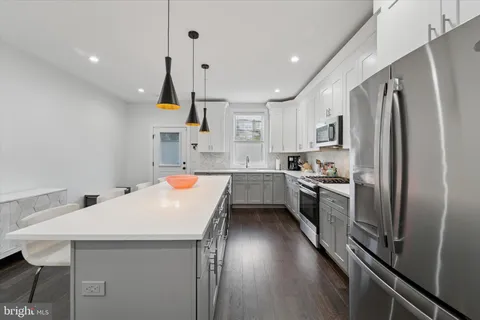 a kitchen with refrigerator and stove