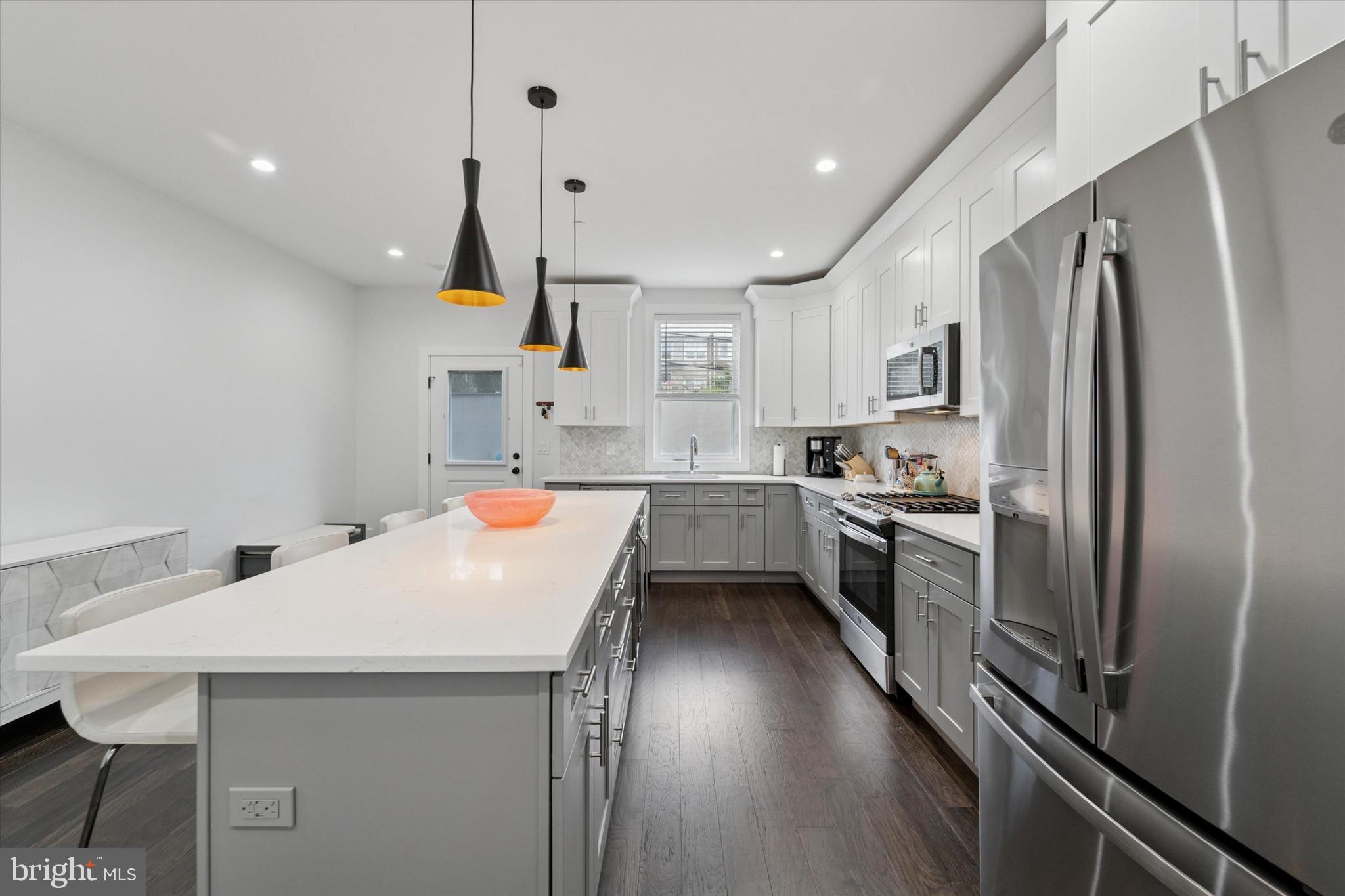 73 East Sharpnack Street Philadelphia, PA 19119 - Photo 6 of 50 a kitchen with refrigerator cabinets and wooden floor