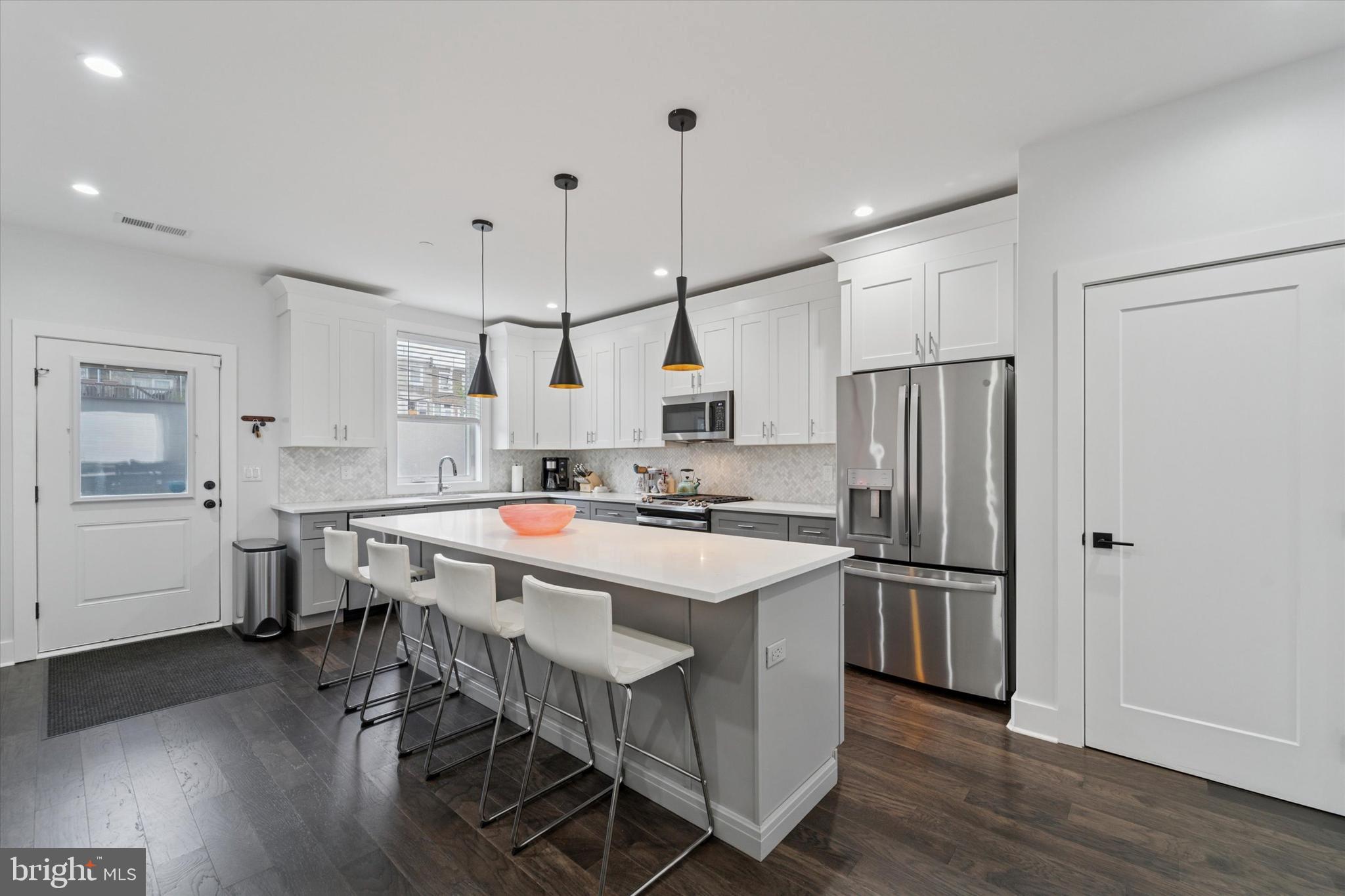73 East Sharpnack Street Philadelphia, PA 19119 - Photo 7 of 50 a kitchen with refrigerator and stove