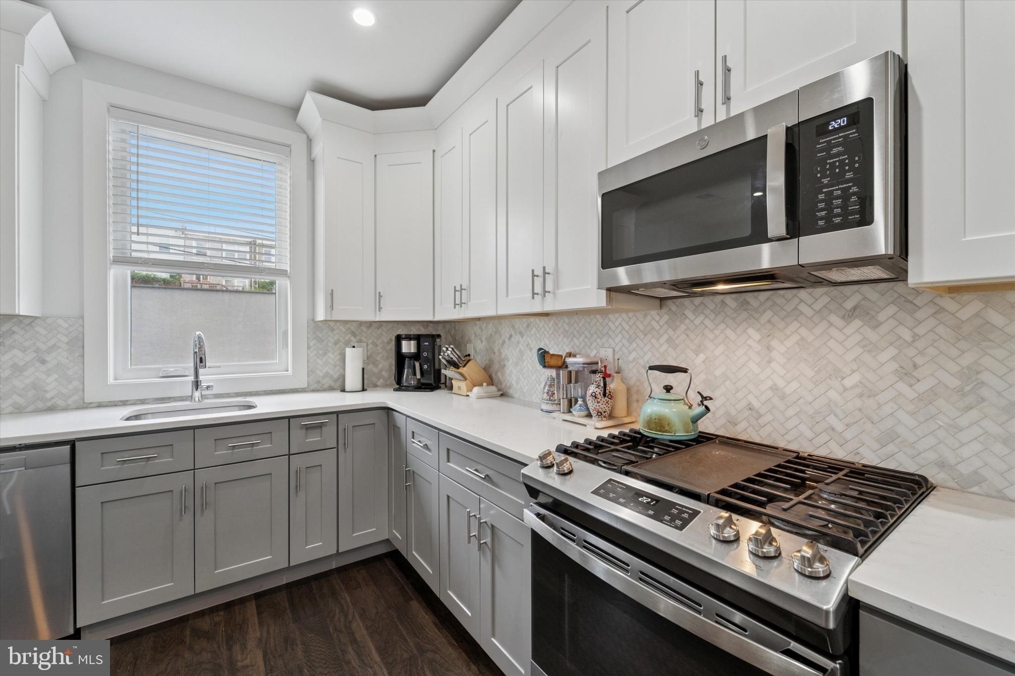 73 East Sharpnack Street Philadelphia, PA 19119 - Photo 9 of 50 a kitchen with stainless steel appliances a sink a stove and microwave