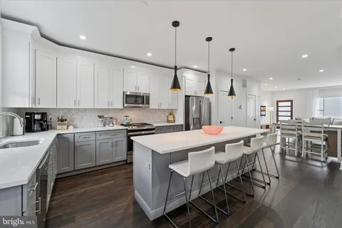a kitchen with a sink a stove and cabinets