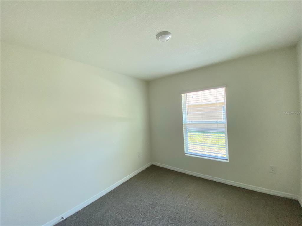 492 Hickory Course Loop Ocala, FL 34472 - Photo 13 of 28 an empty room with a window