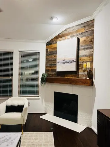 a living room with a fireplace and a large window