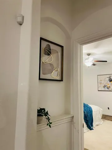 a room with a bed and a painting on the wall