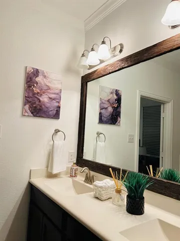 a bathroom with a sink a mirror and vanity