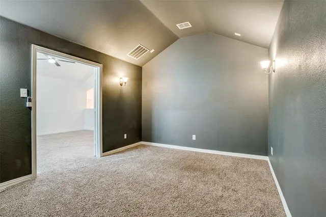 an empty room with fan and entrance