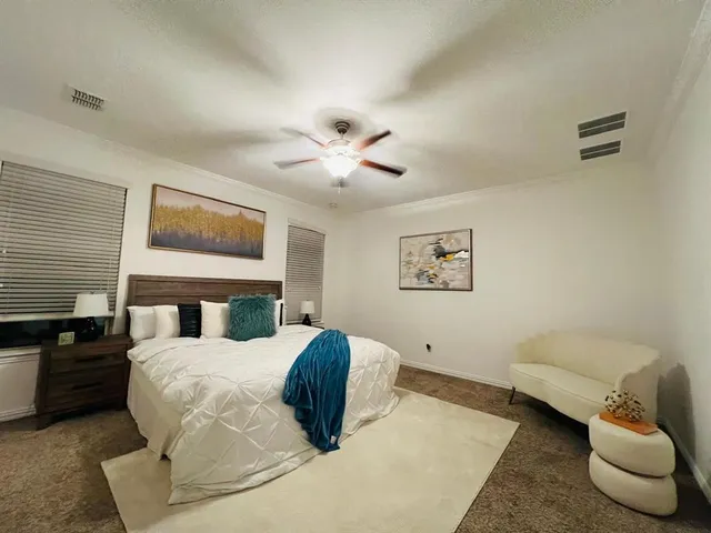 a bedroom with a bed and a couch