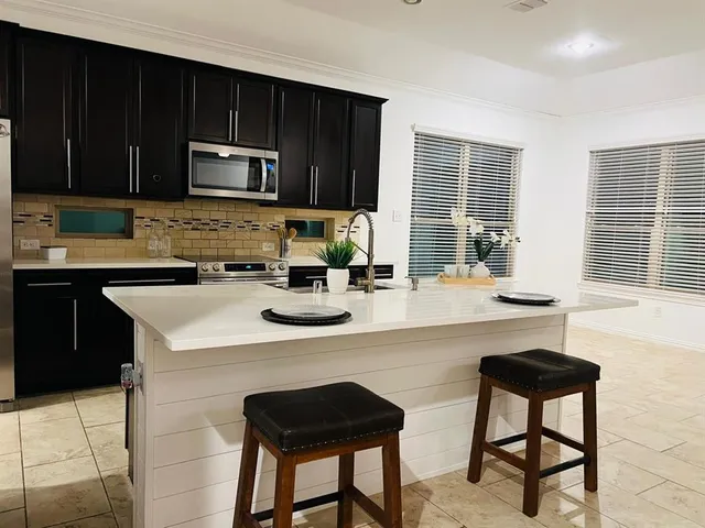 a kitchen with a stove a sink and a microwave