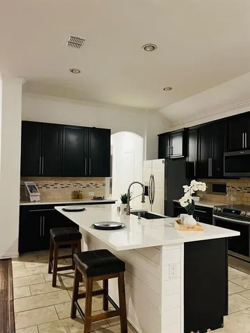 a kitchen with a sink and cabinets