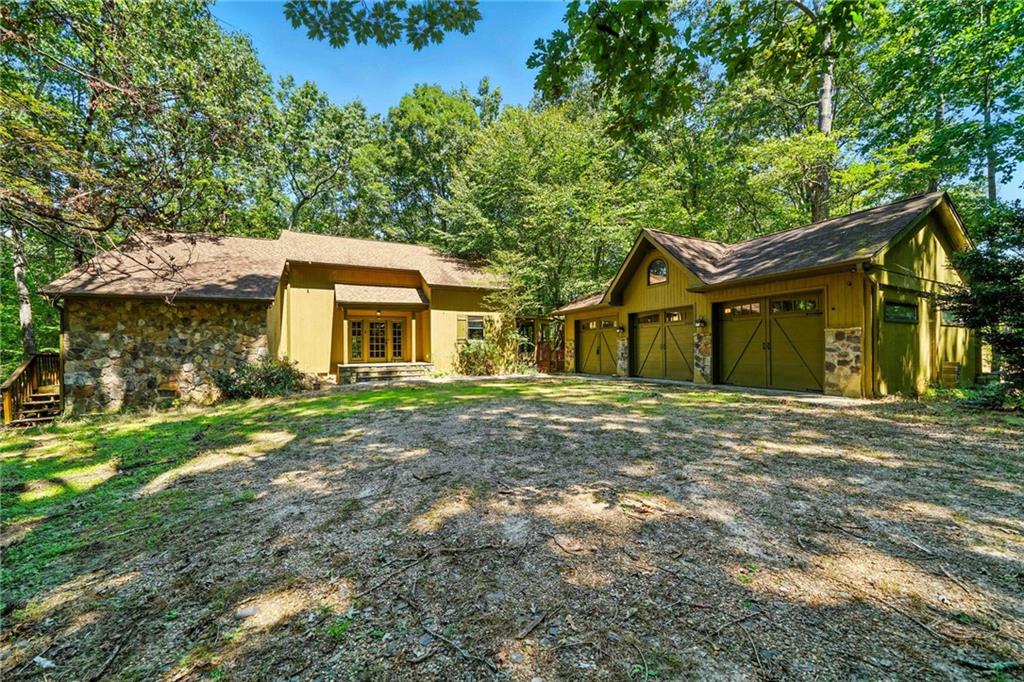 4585 Settles Bridge Road Suwanee, GA 30024 - Photo 1 of 1 a front view of a house with a garden