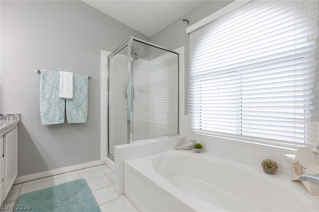 2254 Ramsgate Drive Henderson, NV 89074 - Photo 22 of 43 A well-lit primary bath features a spacious soaking tub and a dedicated shower enclosure.