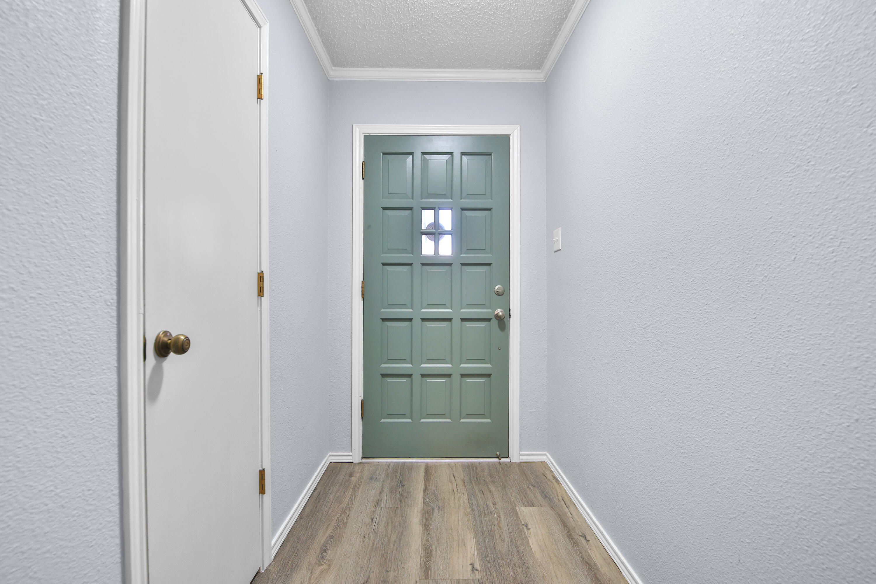 4805 73rd Street Lubbock, TX 79424 - Photo 5 of 26 a view of a hallway with wooden floor and a bathroom