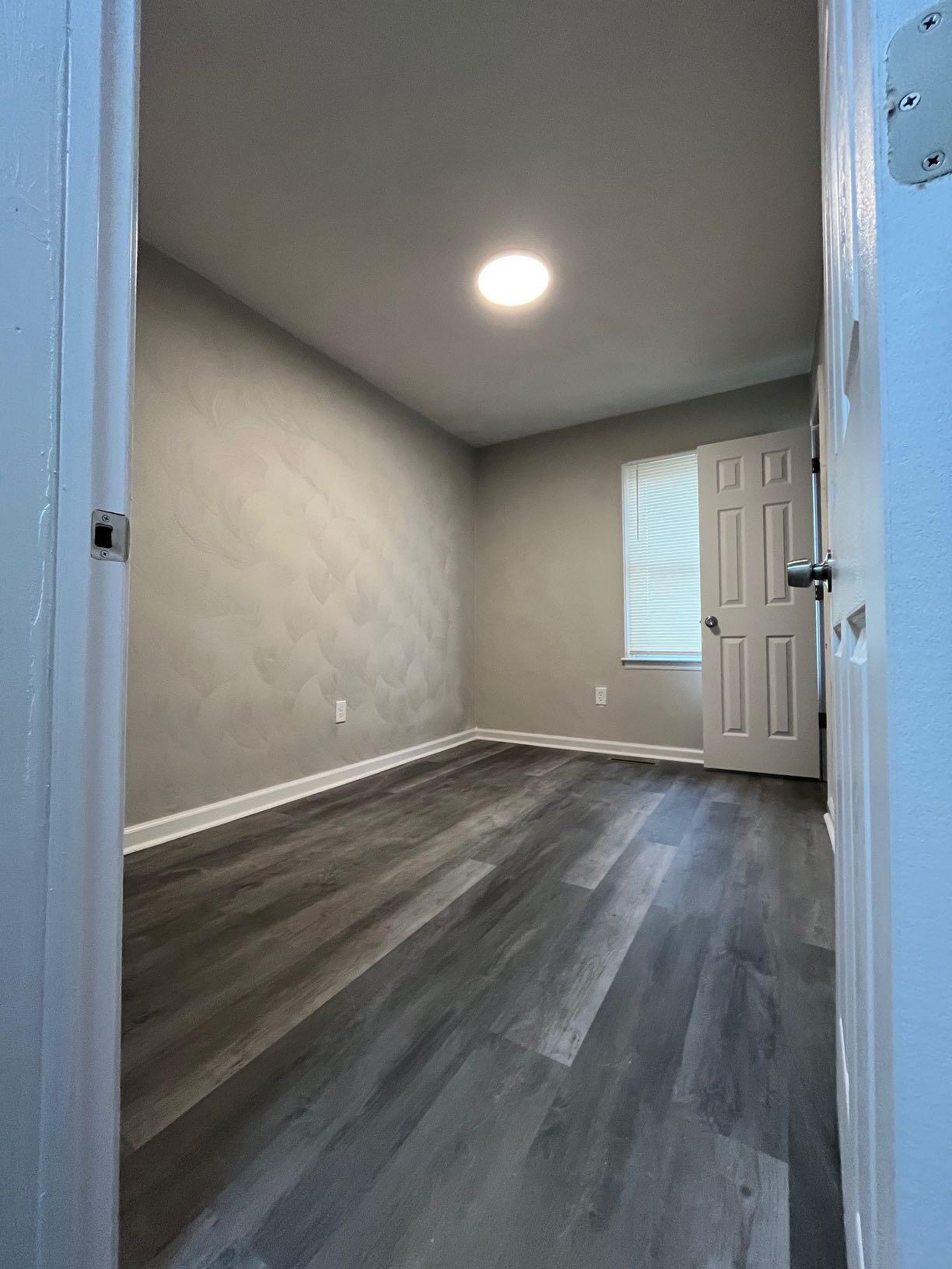 1334 Belleview Avenue Southeast Roanoke, VA 24014 - Photo 7 of 13 an empty room with wooden floor and windows