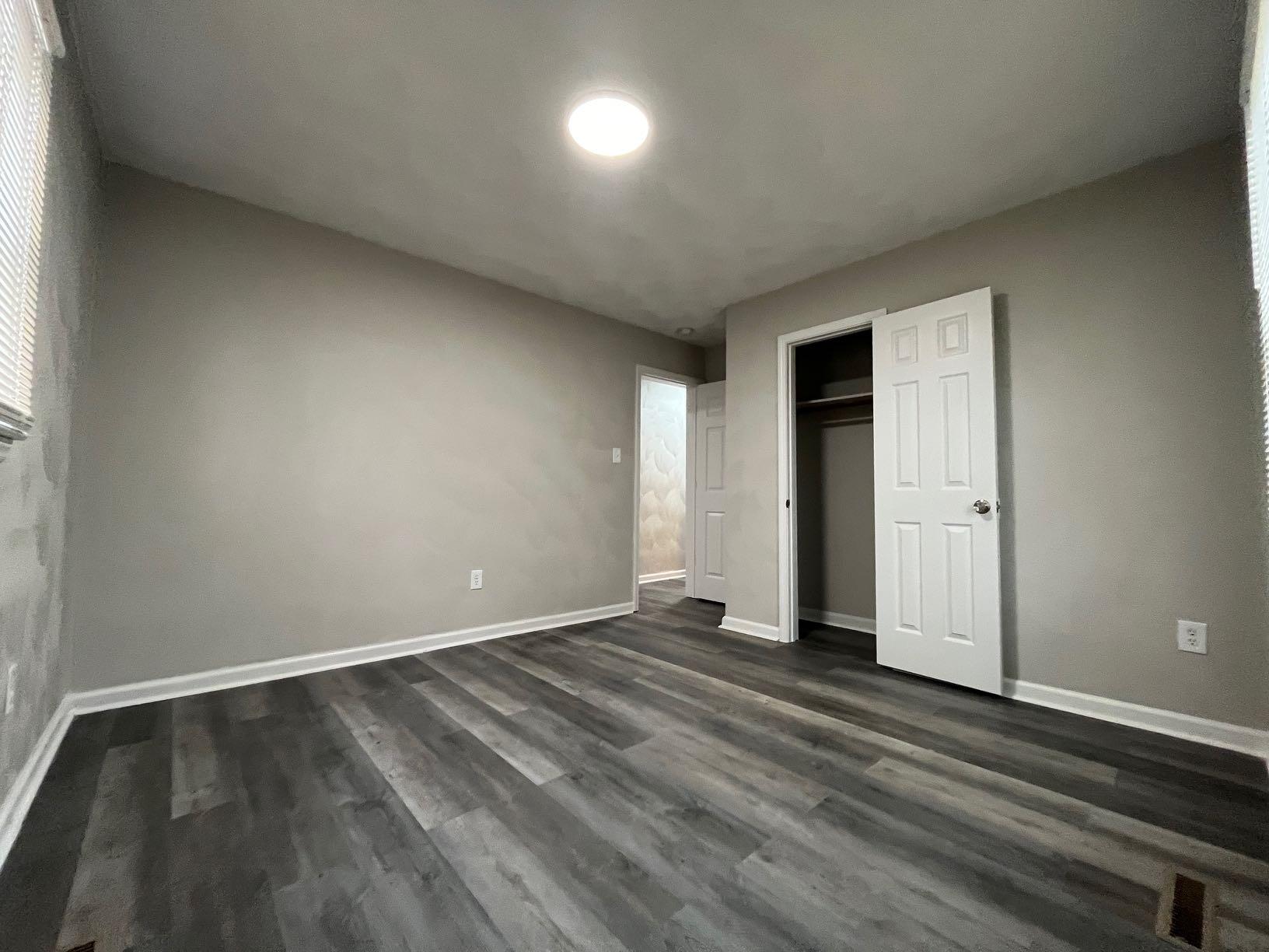 1334 Belleview Avenue Southeast Roanoke, VA 24014 - Photo 8 of 13 an empty room with wooden floor and windows