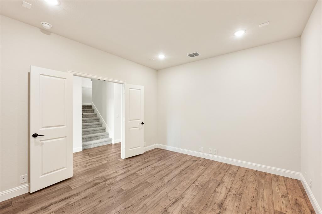 11716 Flathead Court Godley, TX 76044 - Photo 11 of 40 wooden floor in an empty room with wooden floor