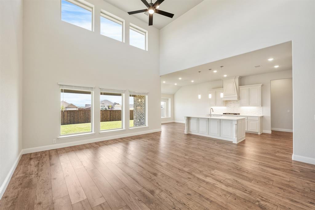 11716 Flathead Court Godley, TX 76044 - Photo 17 of 40 a view of an empty room with a kitchen and a window