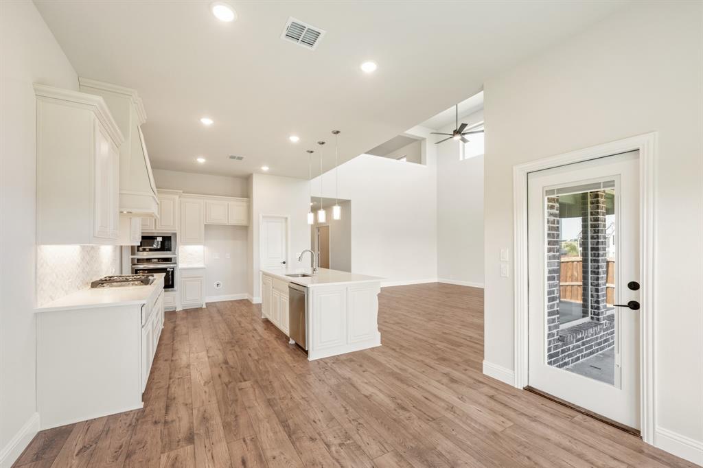 11716 Flathead Court Godley, TX 76044 - Photo 22 of 40 a view of kitchen with sink and wooden floor