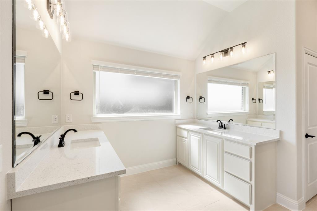 11716 Flathead Court Godley, TX 76044 - Photo 26 of 40 a bathroom with a sink and mirror with window