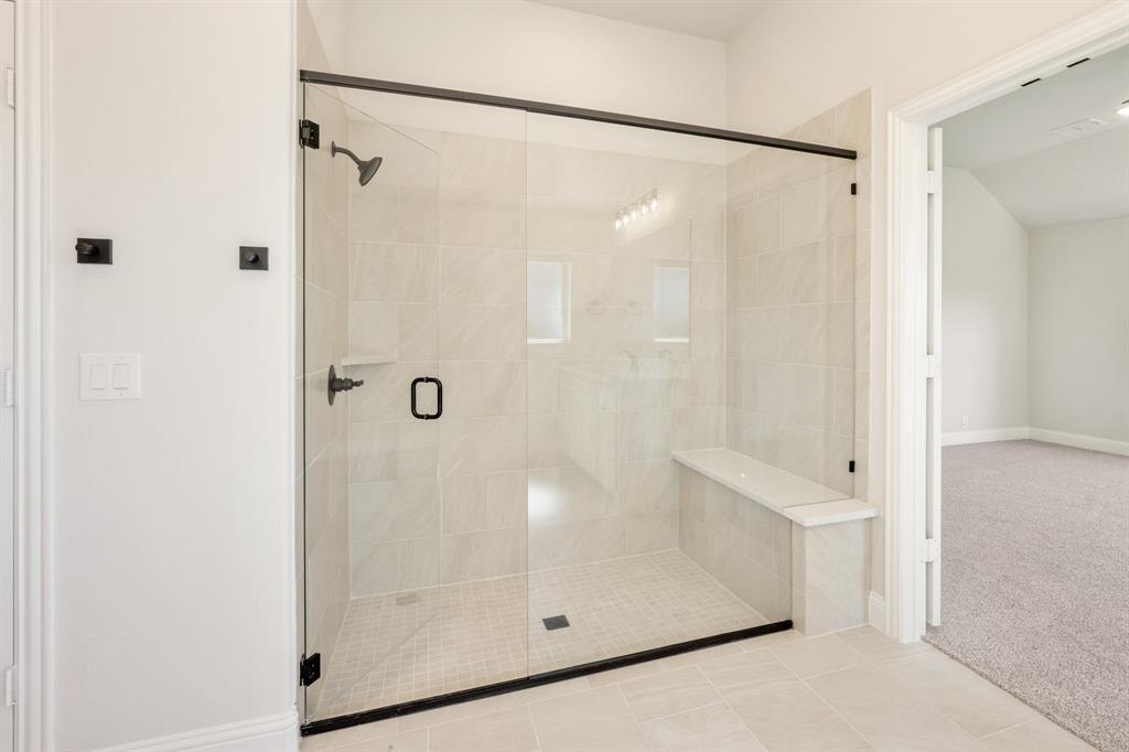 11716 Flathead Court Godley, TX 76044 - Photo 28 of 40 a bathroom with a glass shower door