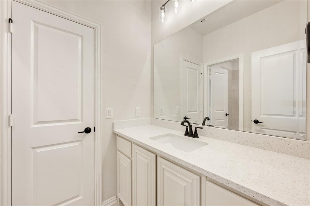 11716 Flathead Court Godley, TX 76044 - Photo 34 of 40 a bathroom with a sink and a mirror