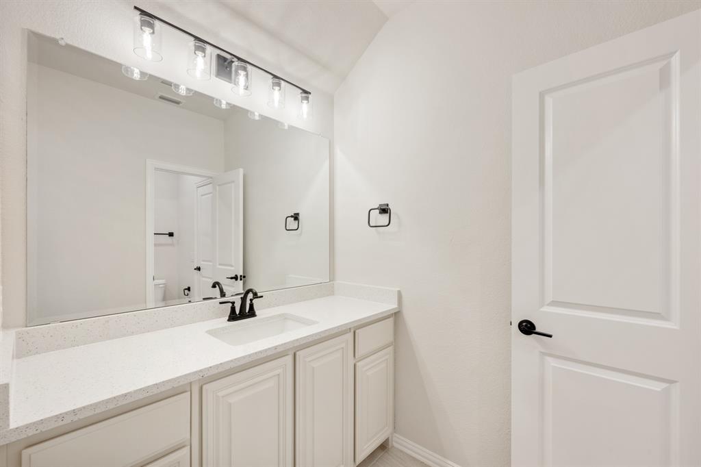 11716 Flathead Court Godley, TX 76044 - Photo 36 of 40 a bathroom with a sink and a mirror