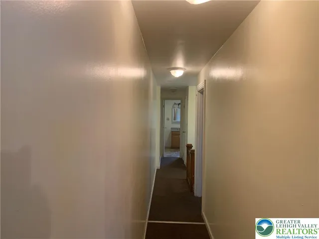 a view of a hallway with a white walls