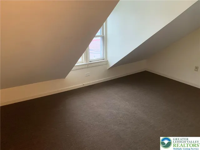 a view of a chairs and table in front of a house